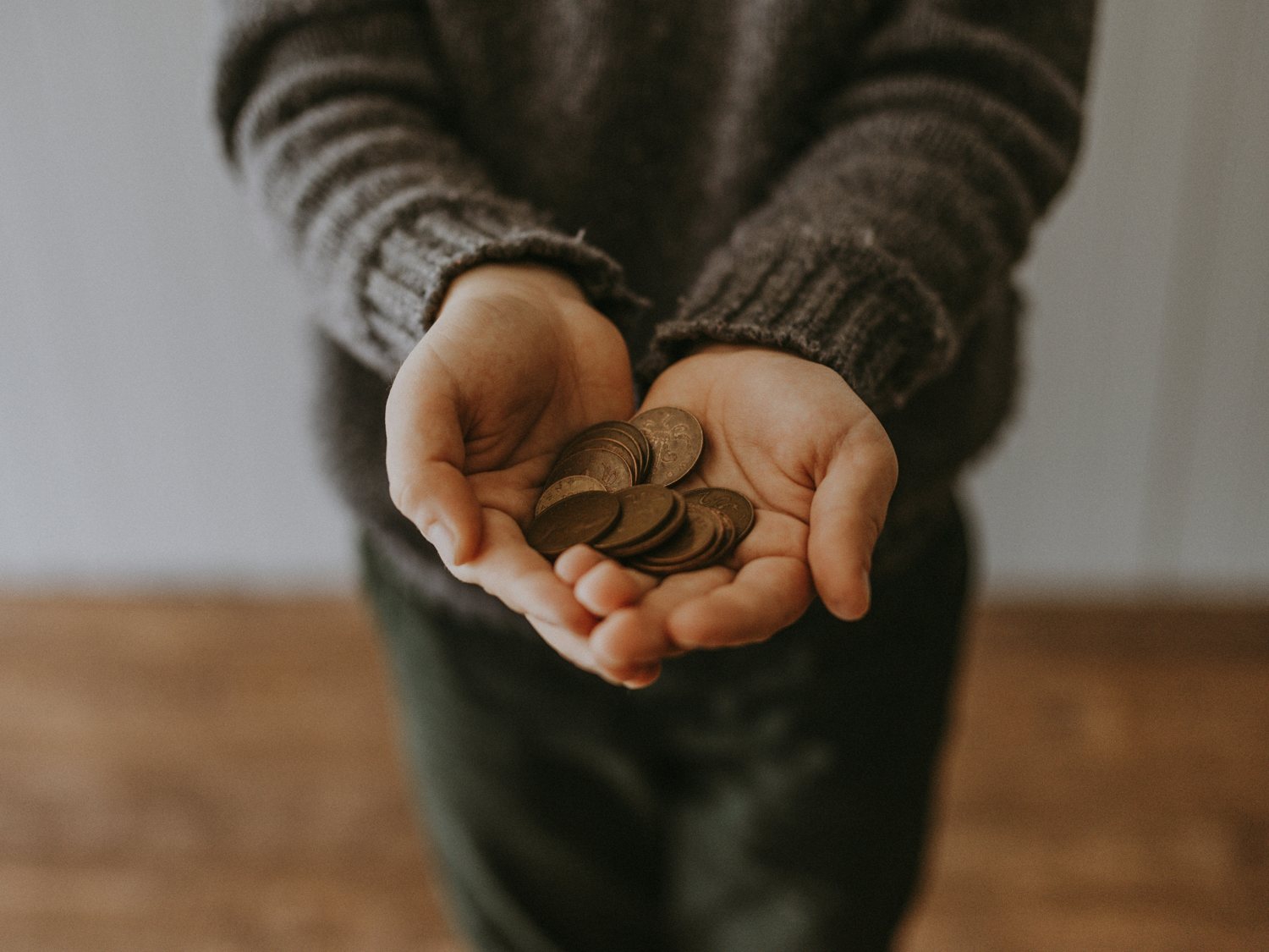 Hands offering coins