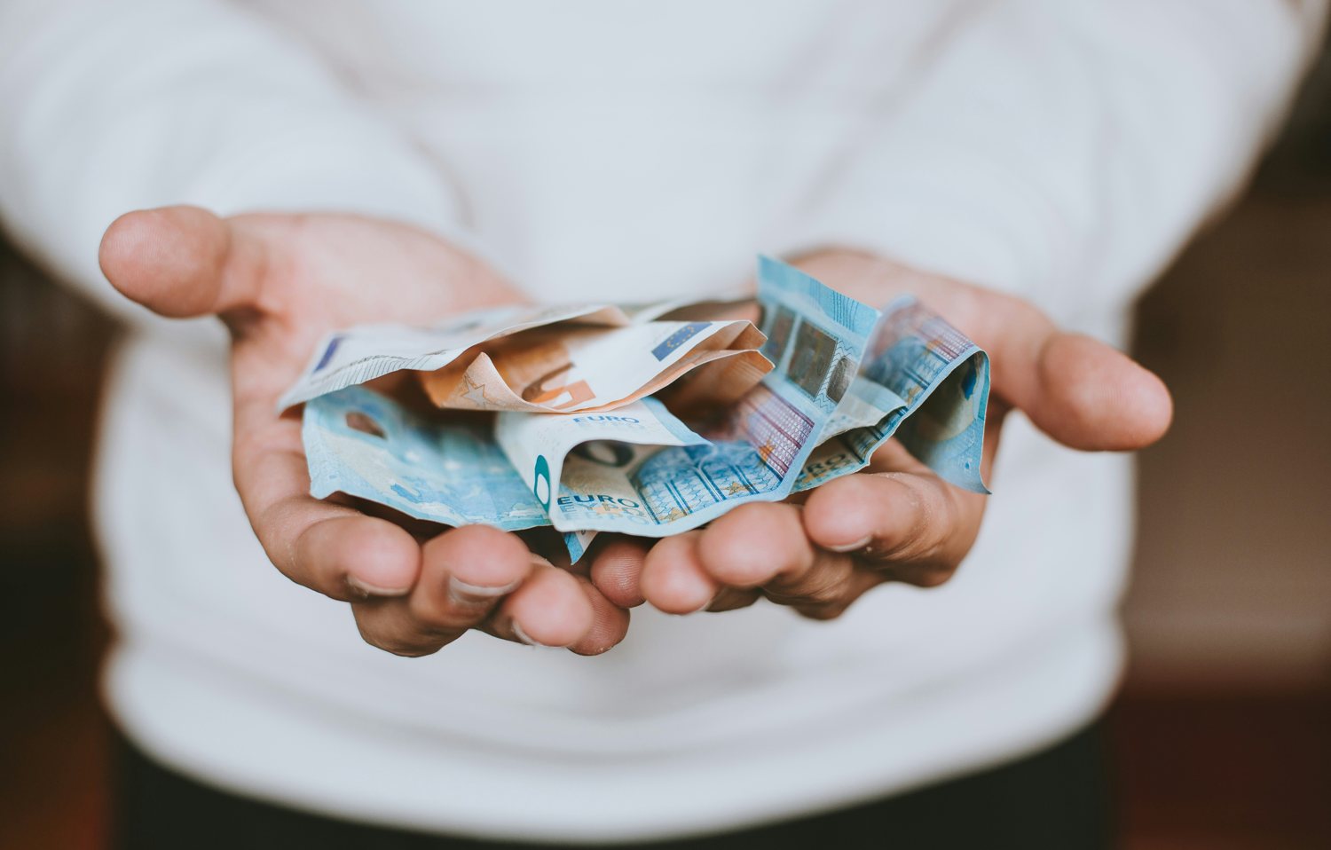 Hands offering banknotes